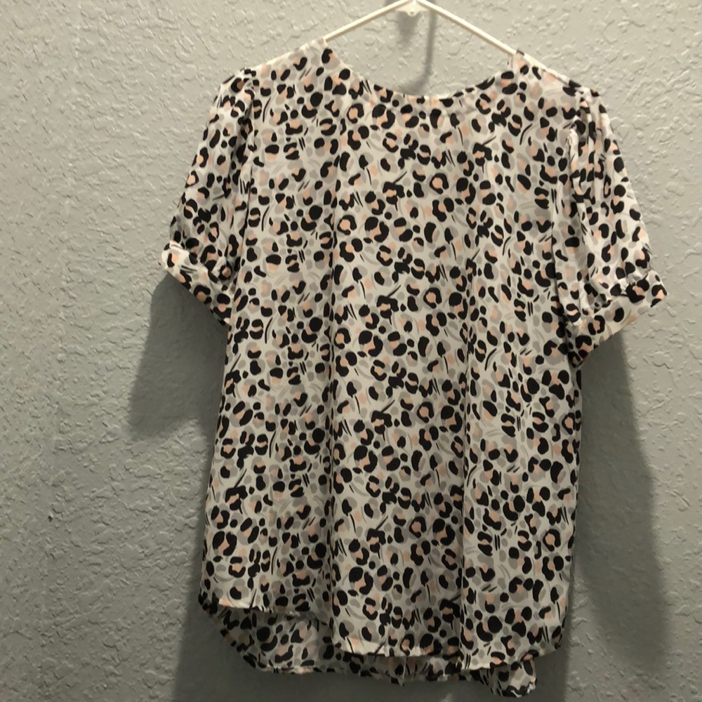 Short sleeve top with back buttons.  Never worn.